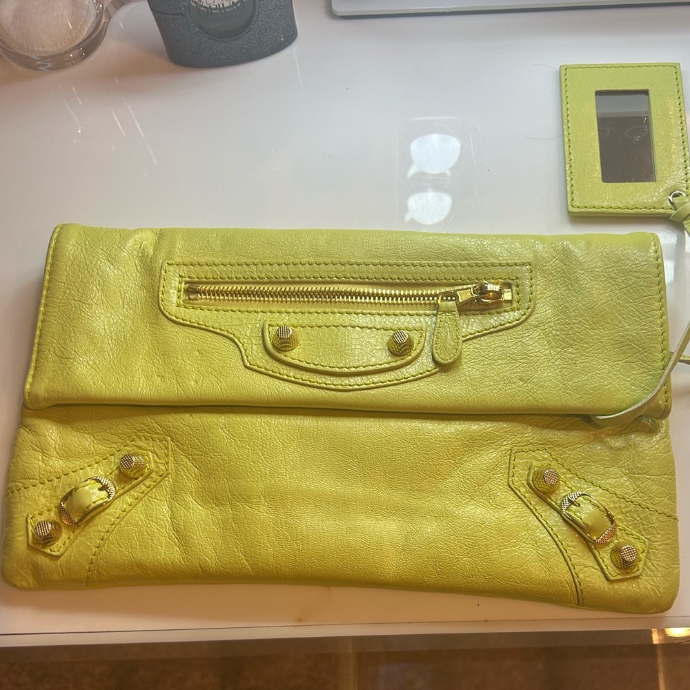 Barely used authentic Balenciega clutch with shoulder strap